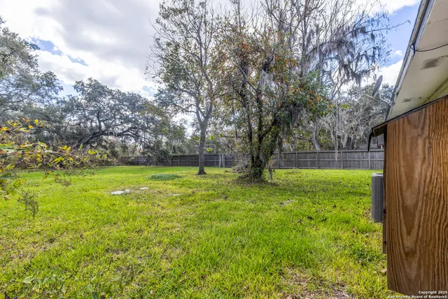 a view of outdoor space with deck and trees