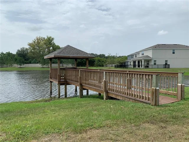 a living room with patio furniture and a floor to ceiling window