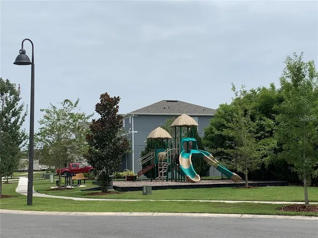 a sign of street next to a building