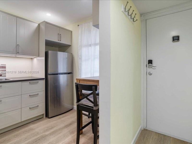 6193 Rock Island Road, Unit 105 Tamarac, FL 33319 - Photo 11 of 24 a kitchen with stainless steel appliances refrigerator and cabinets