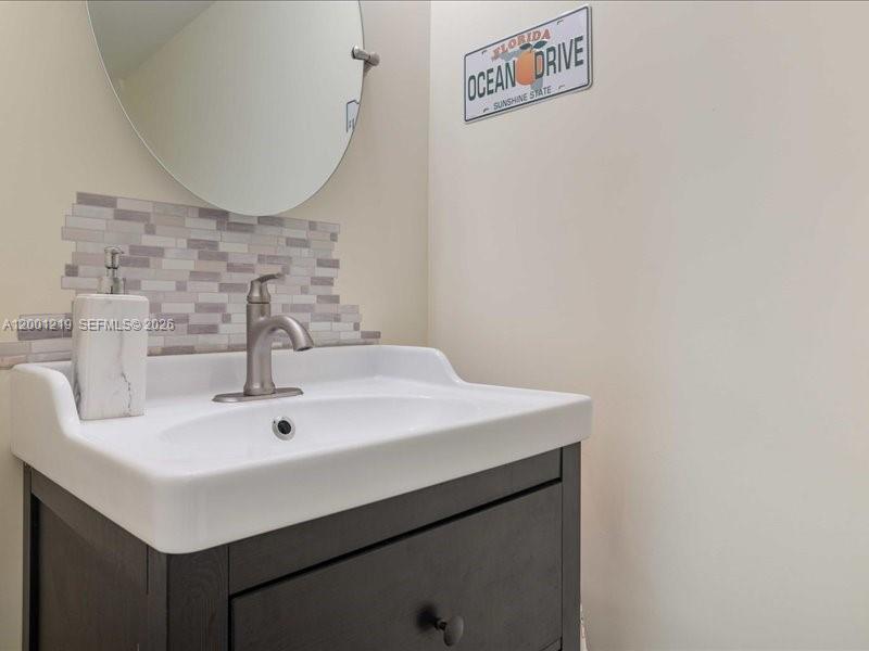 6193 Rock Island Road, Unit 105 Tamarac, FL 33319 - Photo 12 of 24 a bathroom with a sink and a mirror