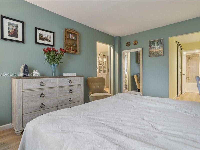 6193 Rock Island Road, Unit 105 Tamarac, FL 33319 - Photo 16 of 24 a bedroom with a bed and a dresser