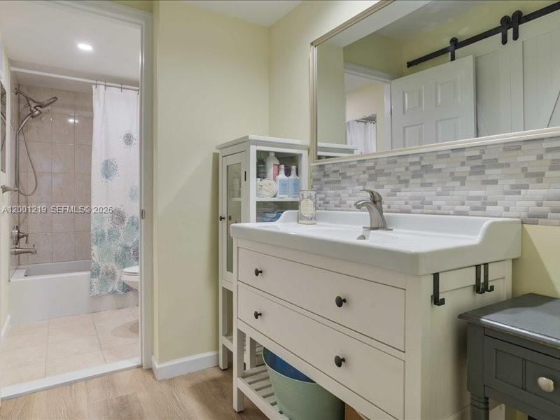 6193 Rock Island Road, Unit 105 Tamarac, FL 33319 - Photo 18 of 24 a bathroom with a sink and a mirror
