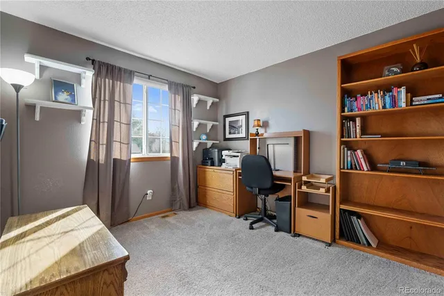 a bed room with a bed and a book shelf