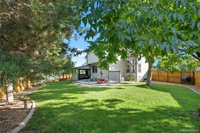 a view of a house with a yard and sitting area