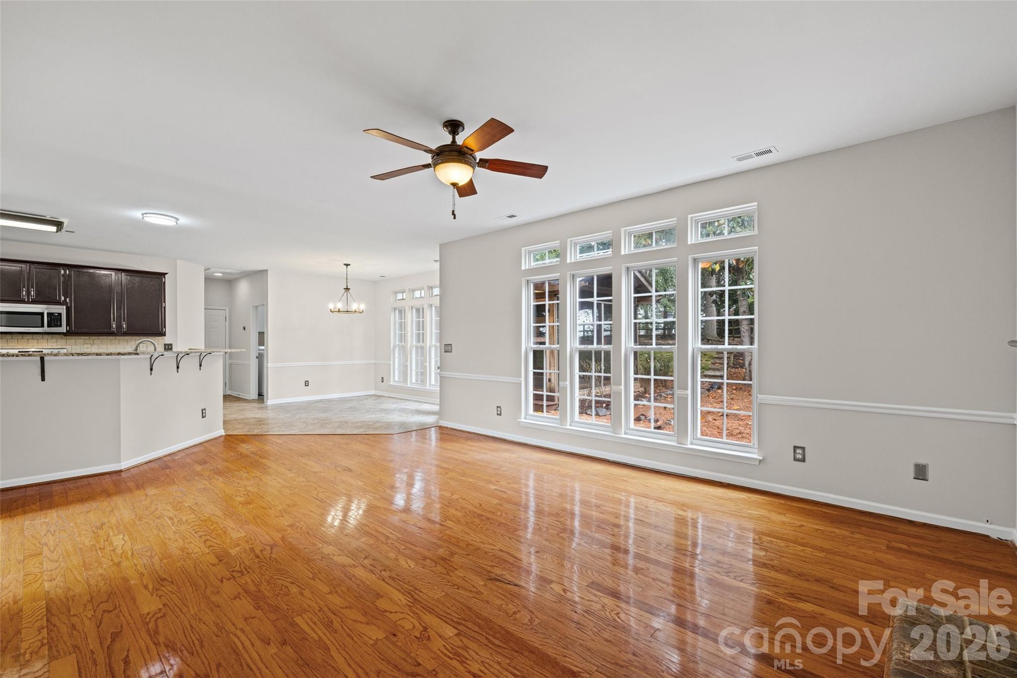 620 East Cheval Drive Fort Mill, SC 29708 - Photo 13 of 48 a view of an empty room with a window and wooden floor