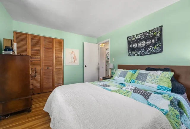 a bedroom with a bed and a large mirror