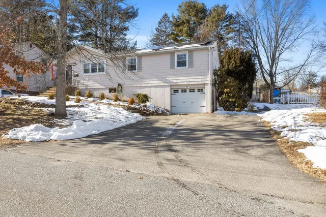 a view of a house with a snow on the road