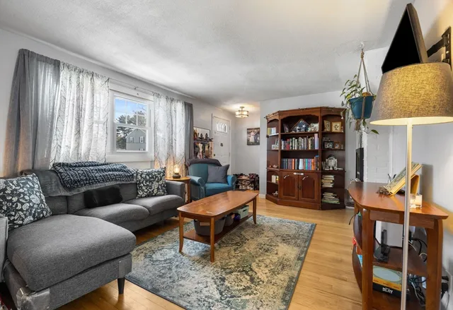 a living room with furniture and a book shelf