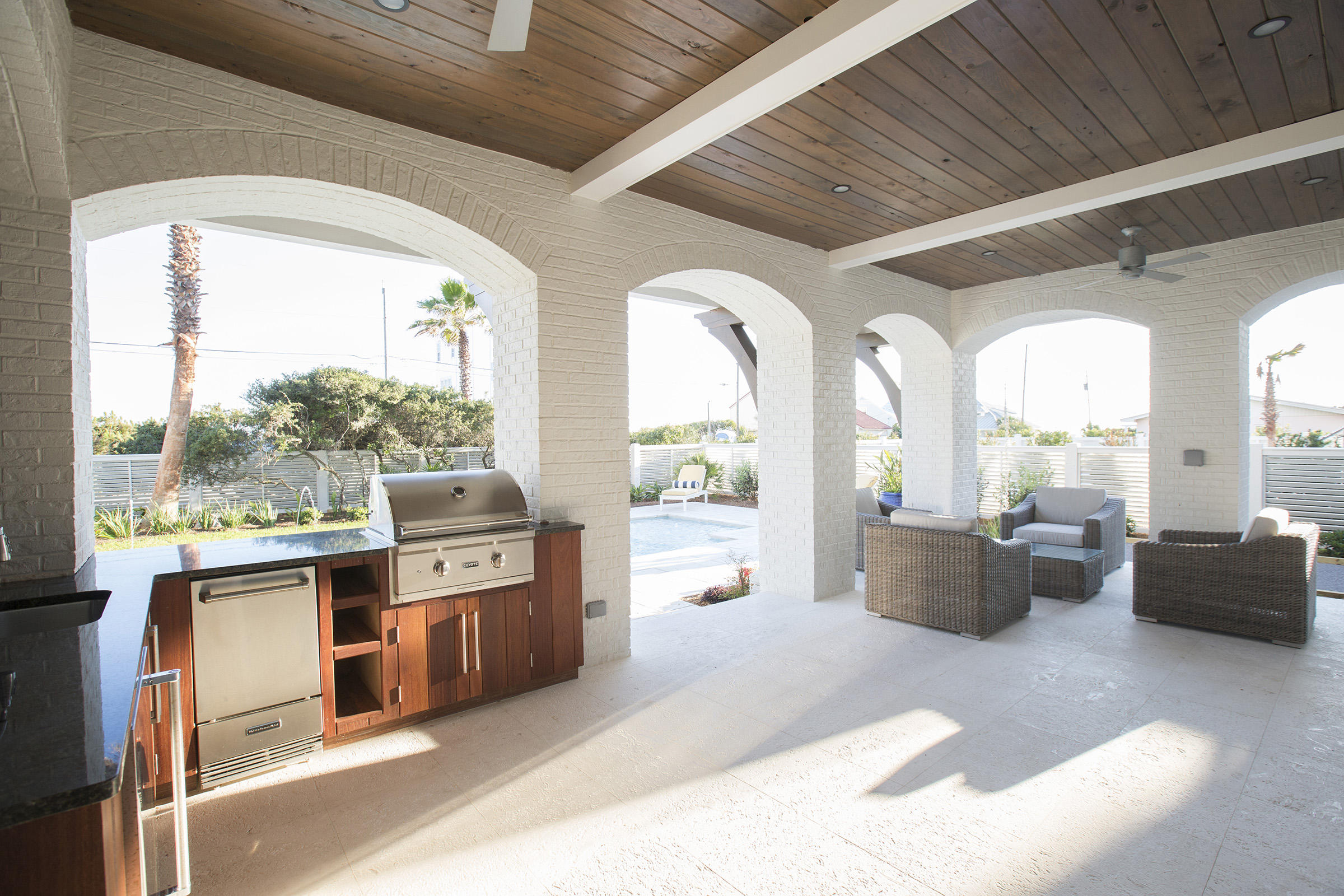 292 Pompano Street Inlet Beach, FL 32461 - Photo 54 of 55 a living room with stainless steel appliances furniture large windows wooden floor and a chandelier