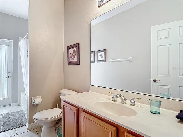 a kitchen with granite countertop white cabinets and stainless steel appliances