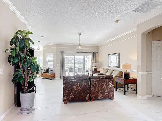 a bathroom with a granite countertop bathtub a sink and a window