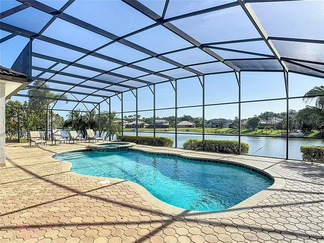 a living room with furniture a chandelier and a flat screen tv