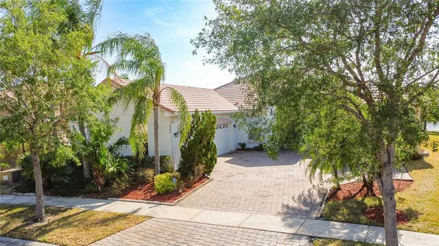 a bathroom with a granite countertop toilet a sink and a mirror