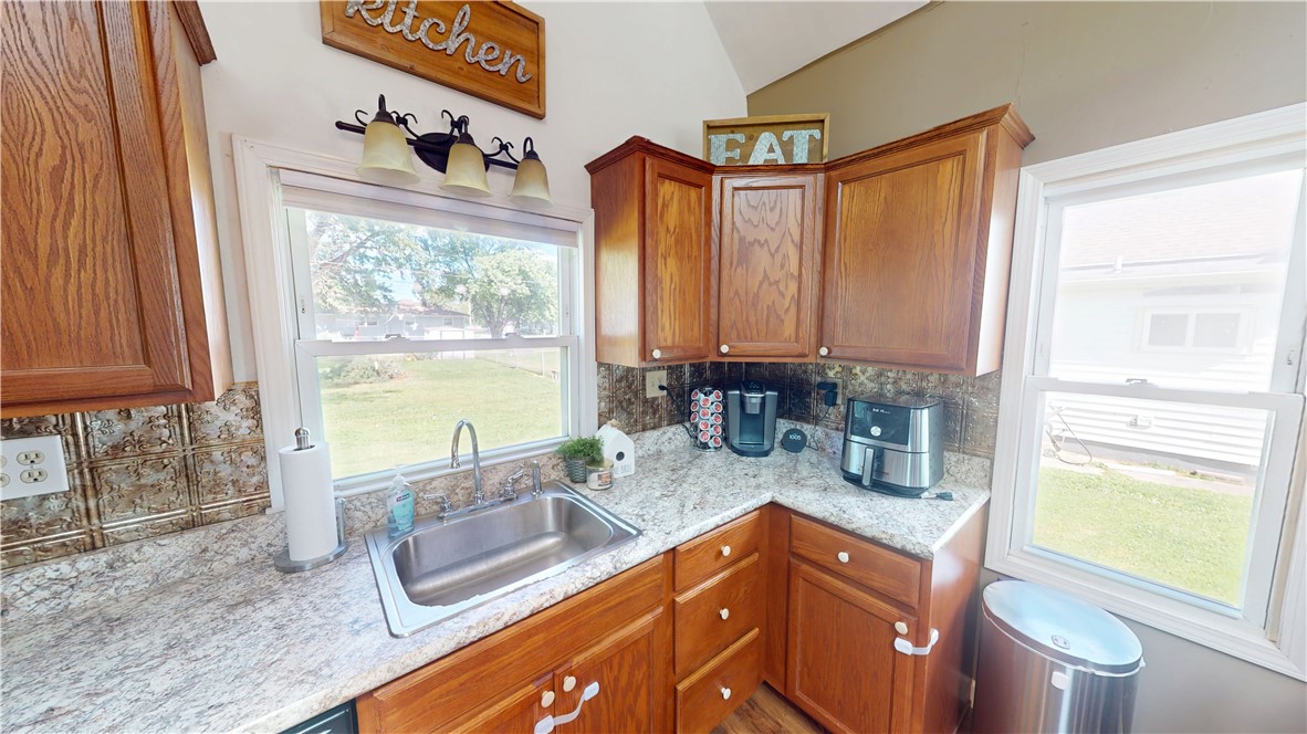 8 Chestnut Street Danville, IL 61832 - Photo 9 of 19 a kitchen with stainless steel appliances granite countertop a sink a stove and a microwave
