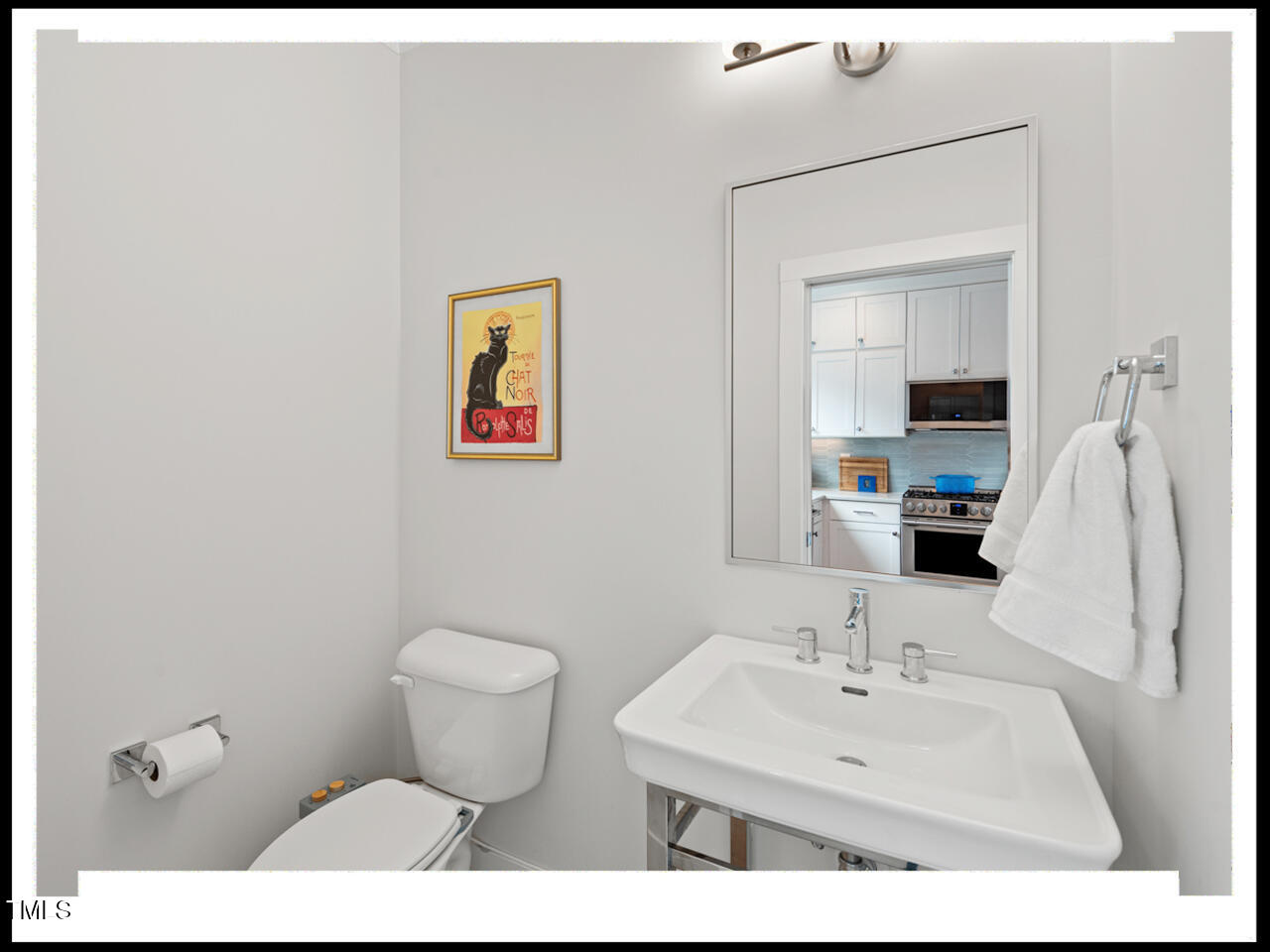 712 East Edenton Street, Unit 105 Raleigh, NC 27601 - Photo 21 of 48 a bathroom with a toilet sink and mirror