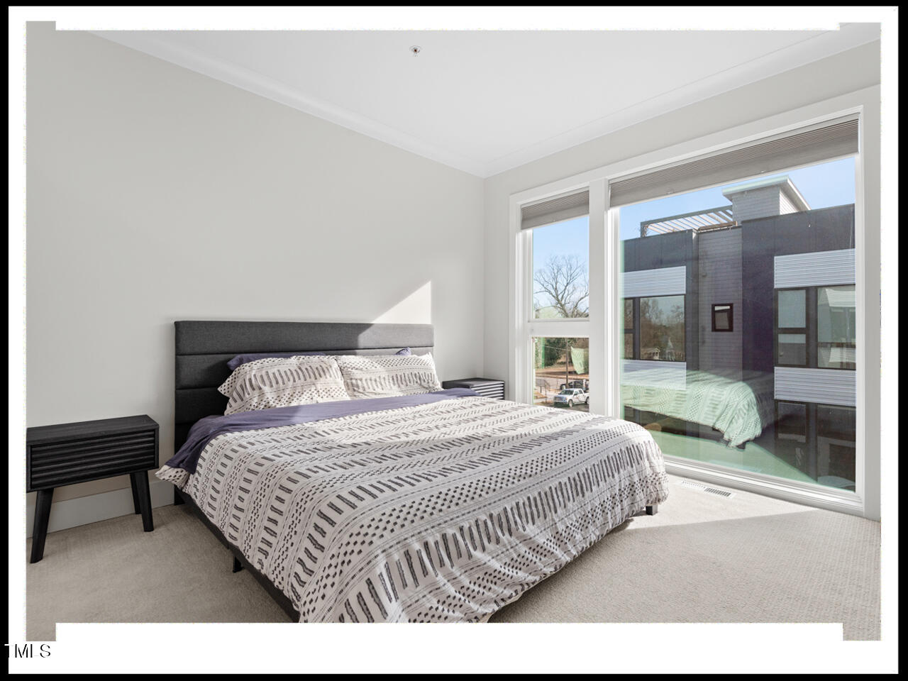 712 East Edenton Street, Unit 105 Raleigh, NC 27601 - Photo 22 of 48 a bedroom with a bed and a large mirror