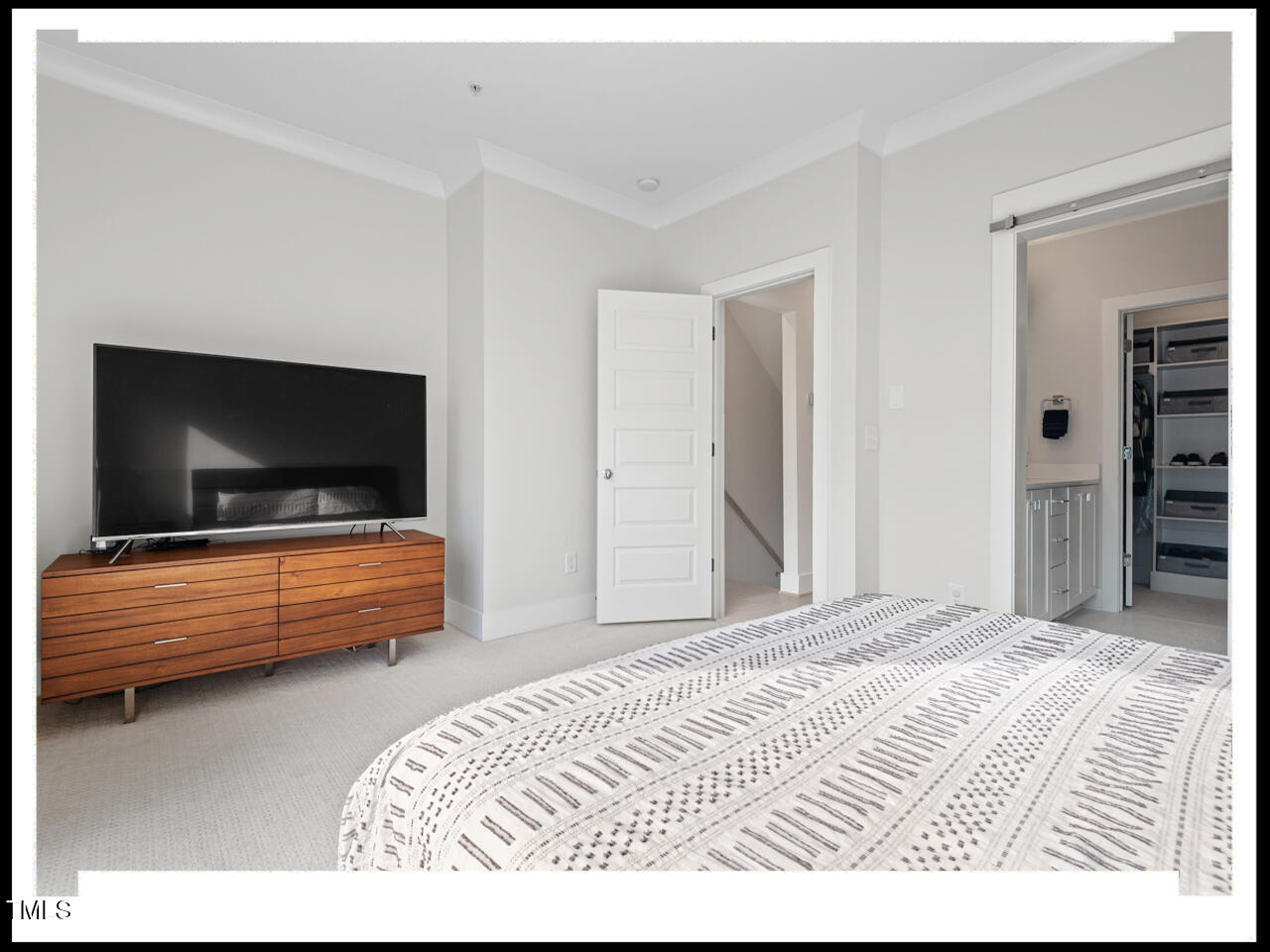 712 East Edenton Street, Unit 105 Raleigh, NC 27601 - Photo 24 of 48 a bedroom with a bed and flat screen tv