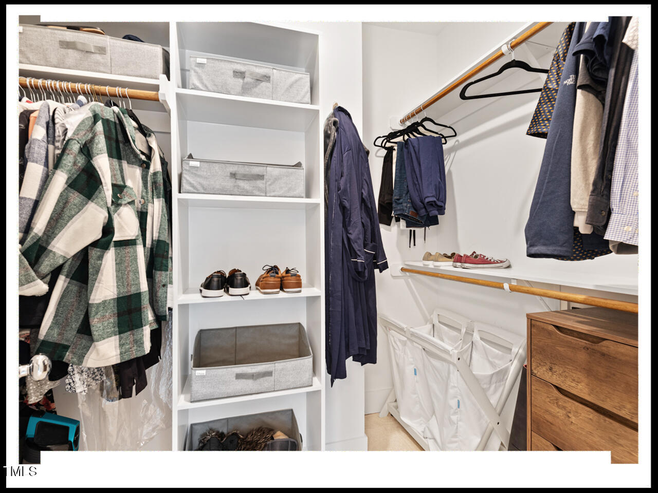712 East Edenton Street, Unit 105 Raleigh, NC 27601 - Photo 29 of 48 a view of walk in closet with clothes and shoes