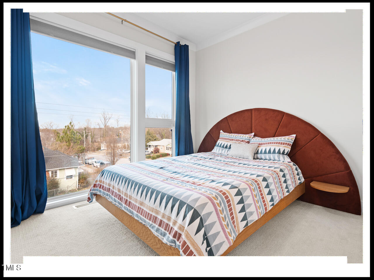 712 East Edenton Street, Unit 105 Raleigh, NC 27601 - Photo 31 of 48 a bedroom with a large bed and a large window