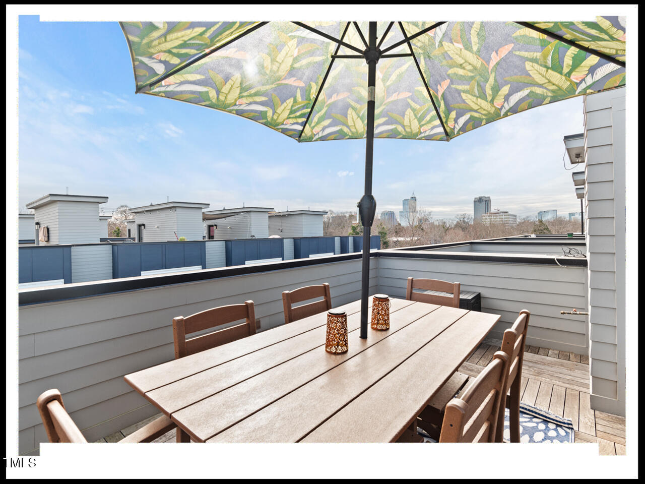 712 East Edenton Street, Unit 105 Raleigh, NC 27601 - Photo 40 of 48 a view of a tables and chair under an umbrella