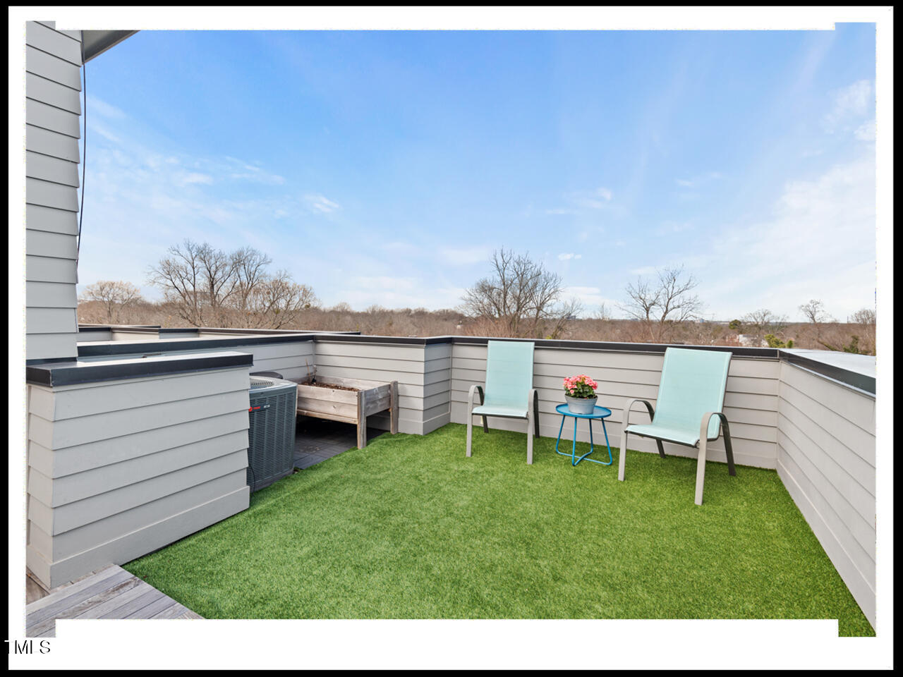 712 East Edenton Street, Unit 105 Raleigh, NC 27601 - Photo 42 of 48 a view of a chair and table on the wooden deck