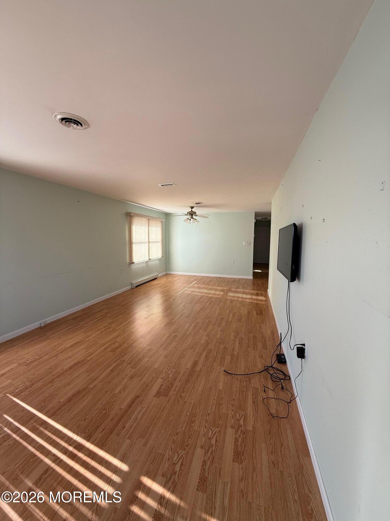 18 Magnolia Road Manahawkin, NJ 08050 - Photo 2 of 10 a view of empty room with wooden floor