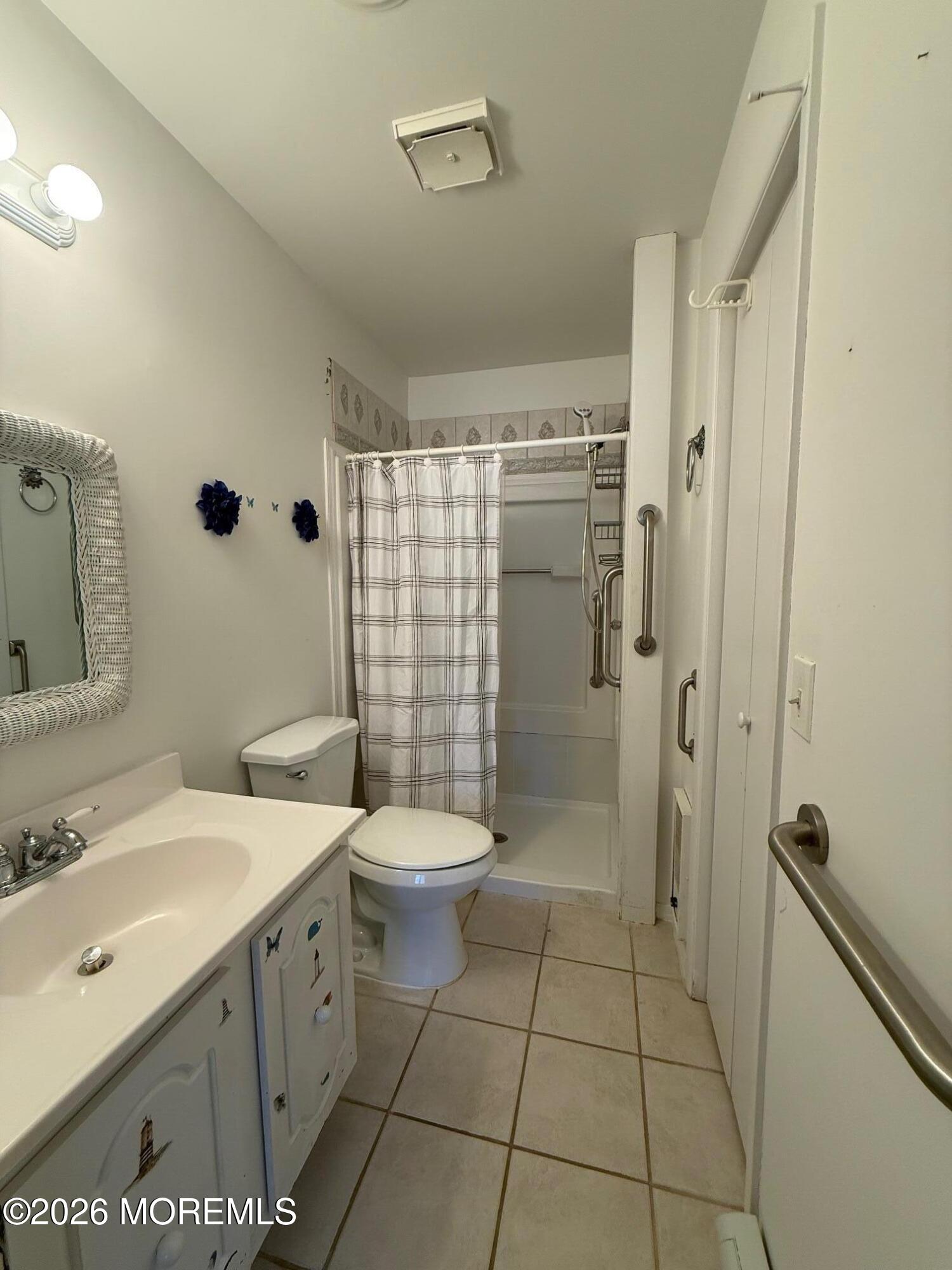 18 Magnolia Road Manahawkin, NJ 08050 - Photo 8 of 10 a bathroom with a toilet sink and shower