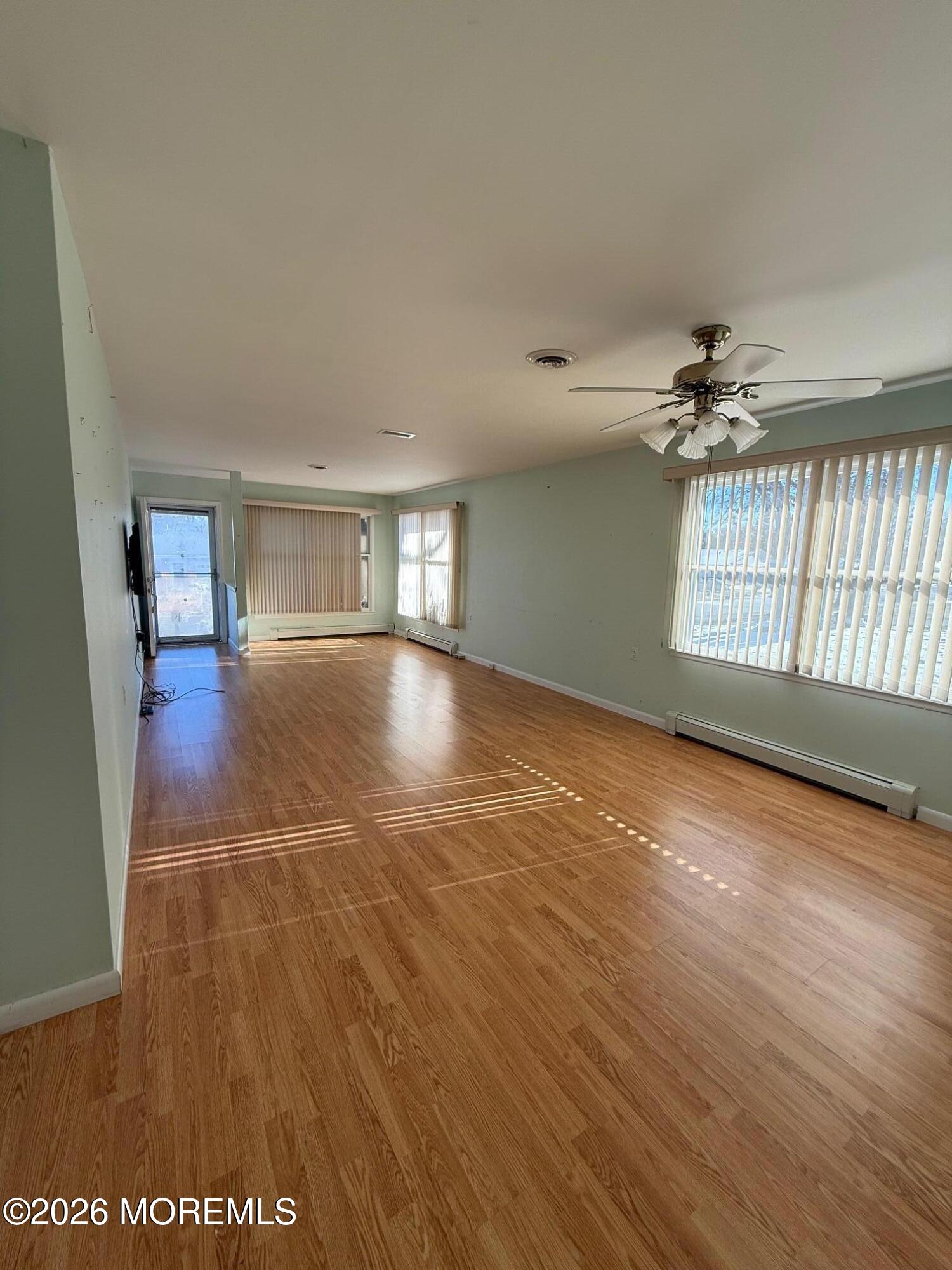 18 Magnolia Road Manahawkin, NJ 08050 - Photo 9 of 10 an empty room with wooden floor and windows