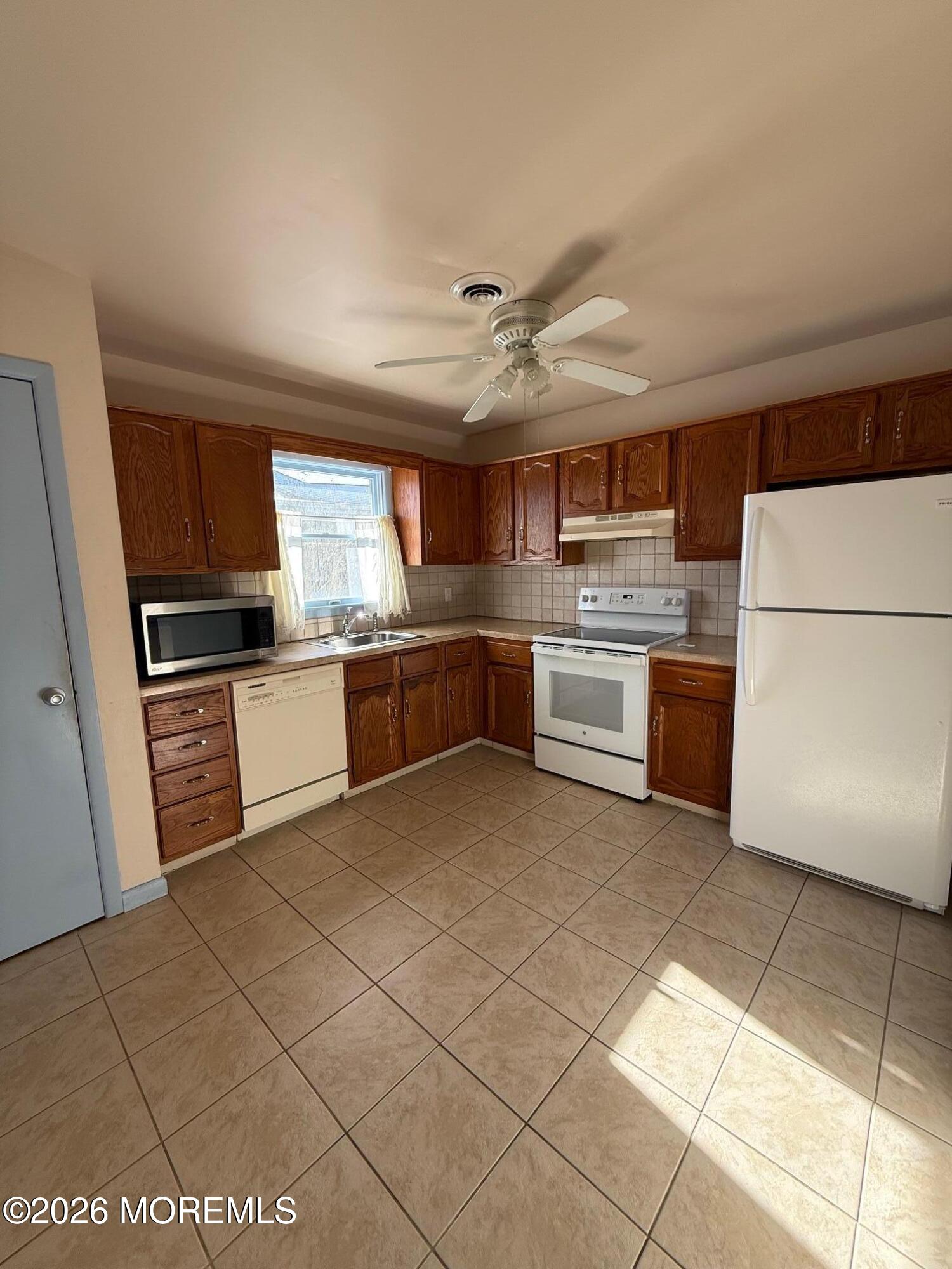 18 Magnolia Road Manahawkin, NJ 08050 - Photo 10 of 10 a kitchen with stainless steel appliances granite countertop a refrigerator sink and stove