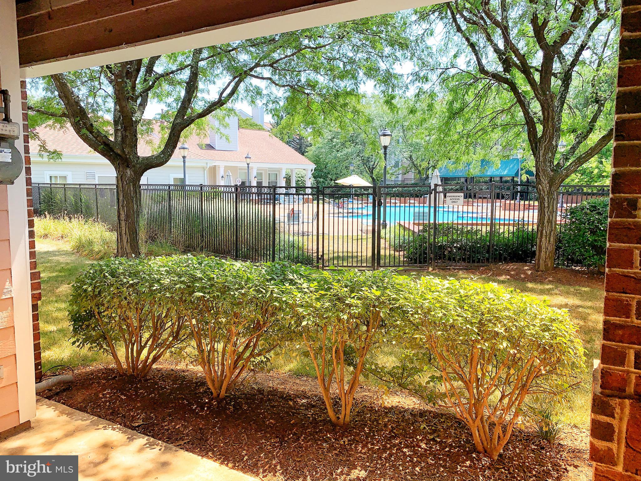 21029 Timber Ridge Terrace, Unit 102 Ashburn, VA 20147 - Photo 1 of 39 View from the patio to the pool