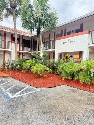 a front view of house with yard and trees around