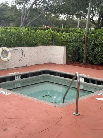 a view of a swimming pool with an outdoor space and seating area