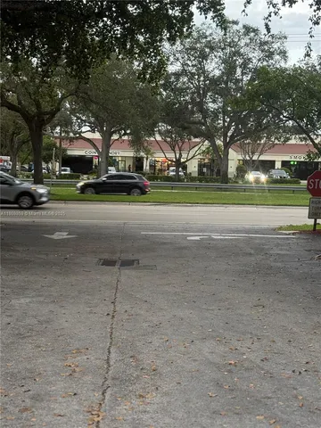 a yellow building with trees in front of it