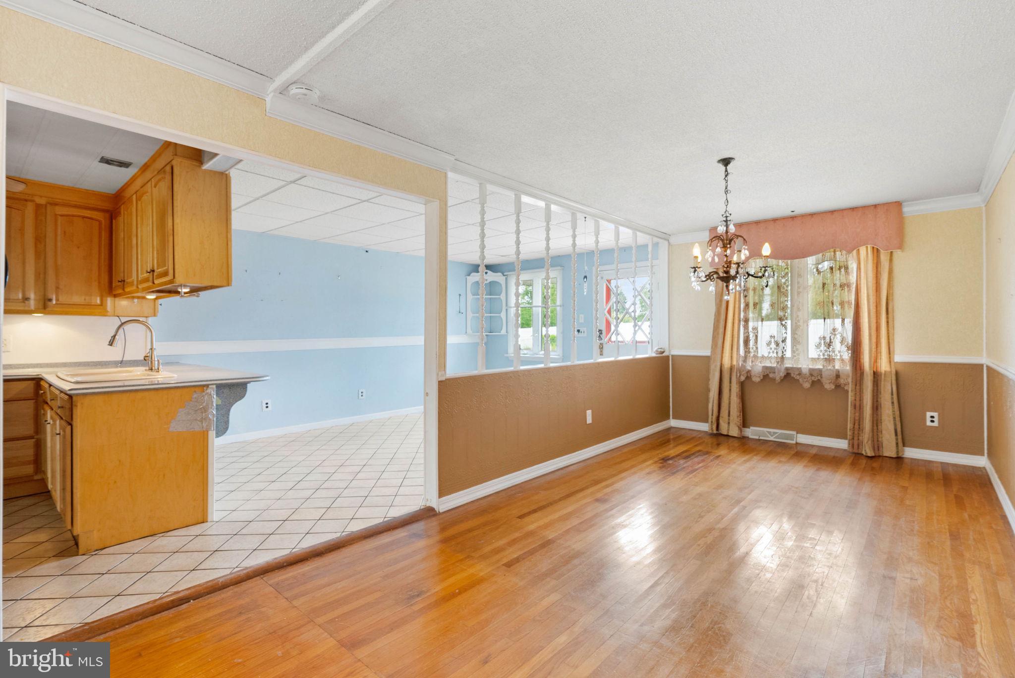 711 George Lane Glendora, NJ 08029 - Photo 12 of 43 a view of an empty room with window and wooden floor