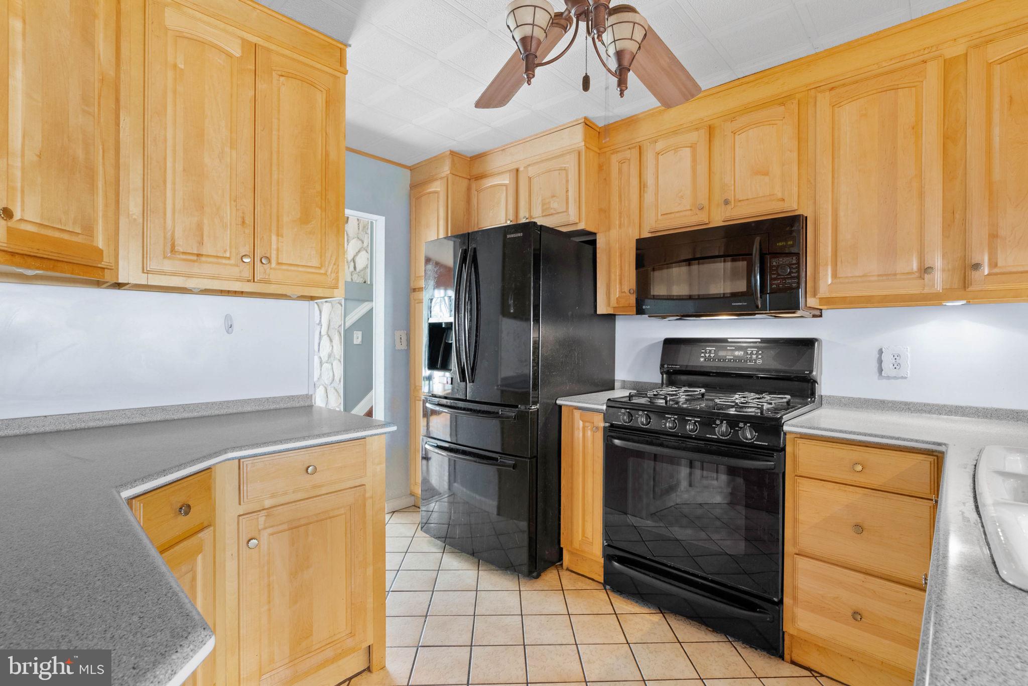 711 George Lane Glendora, NJ 08029 - Photo 16 of 43 a kitchen with stainless steel appliances granite countertop a stove a refrigerator and a microwave
