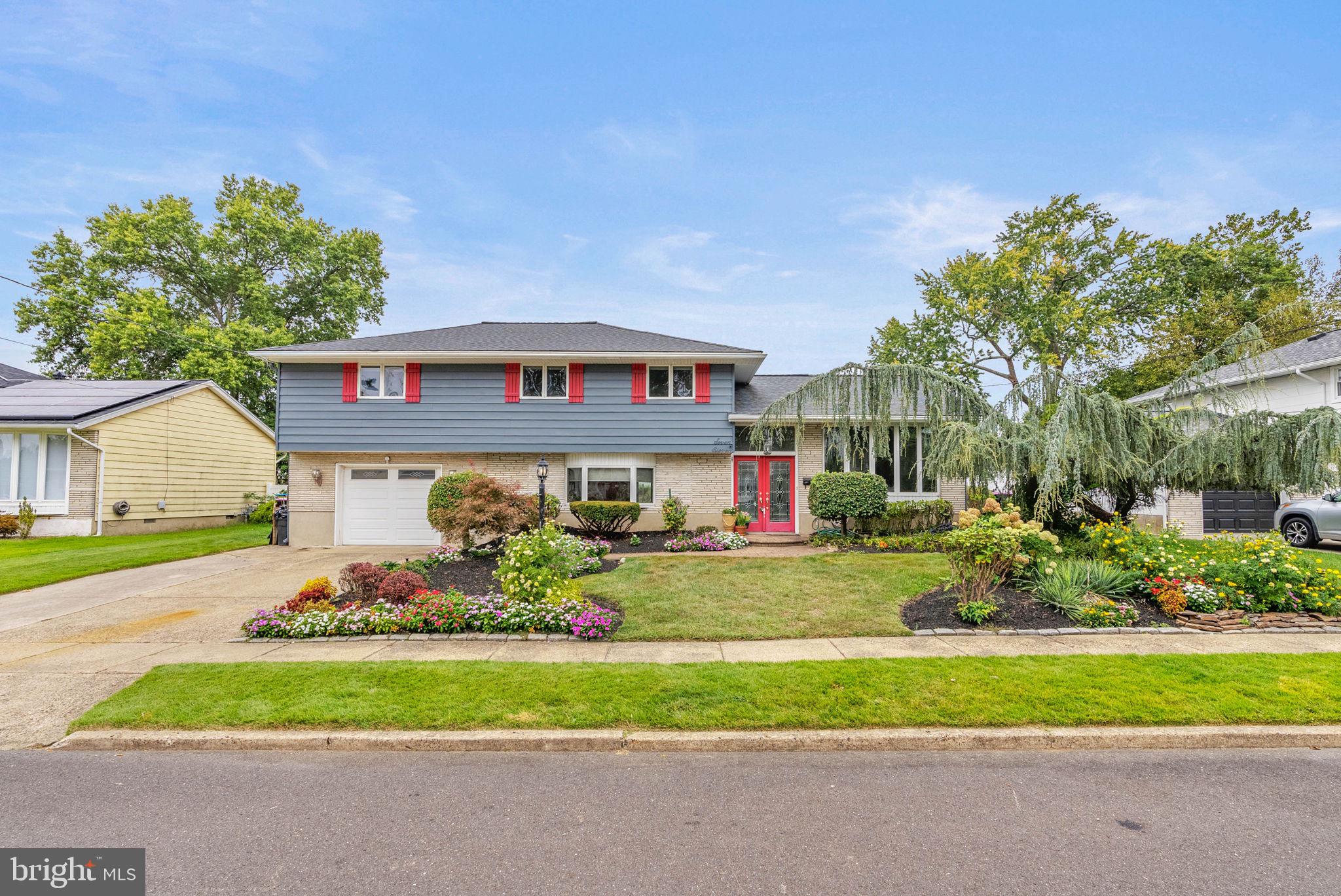 711 George Lane Glendora, NJ 08029 - Photo 2 of 43 a front view of a house with a yard and garage