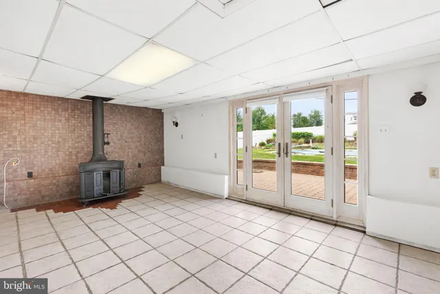 a view of a livingroom with an empty space and a window