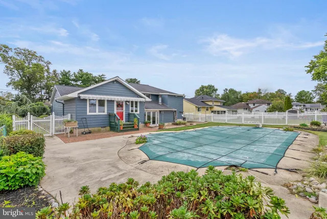 a front view of a house with yard and green space
