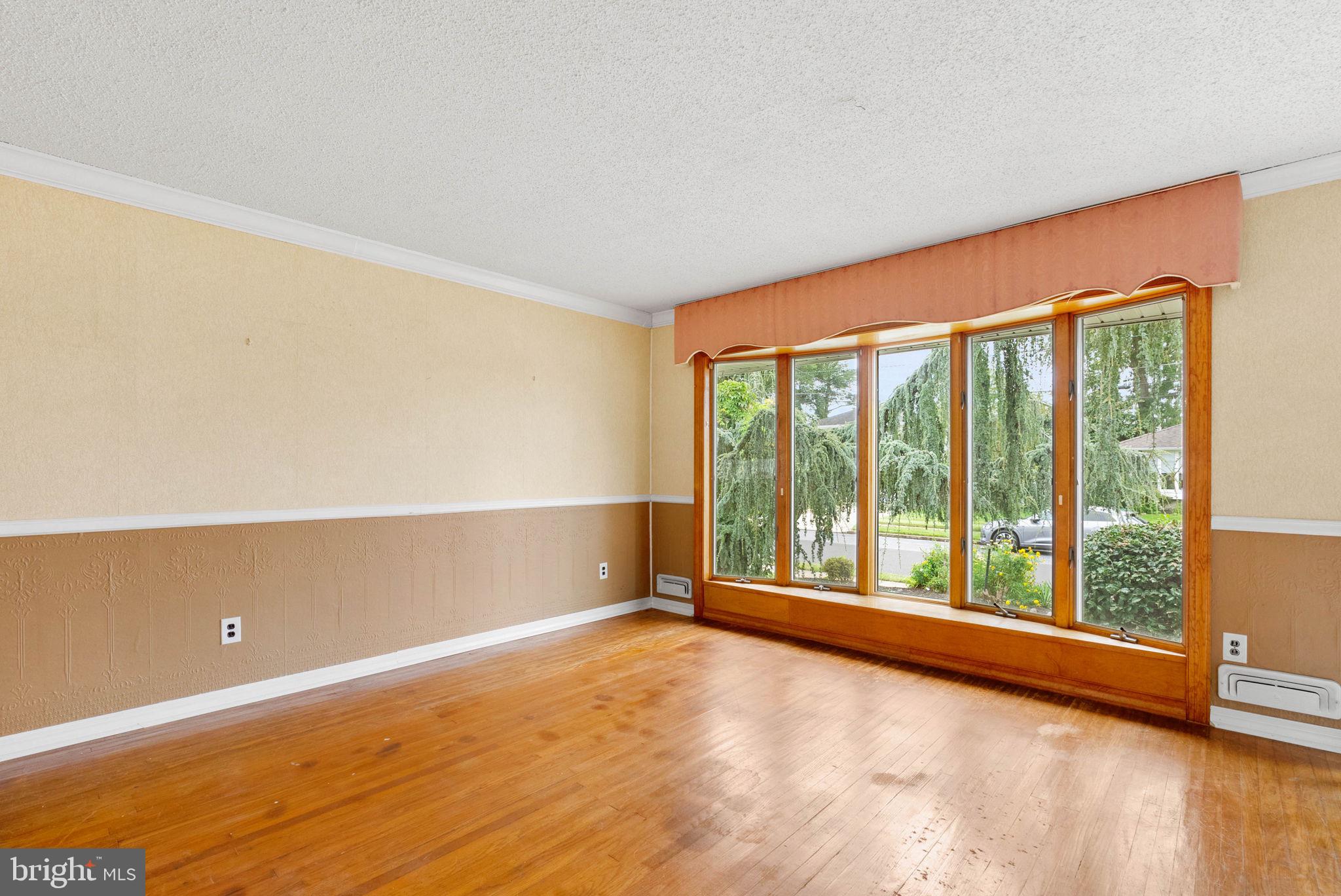 711 George Lane Glendora, NJ 08029 - Photo 9 of 43 a view of an empty room with wooden floor and a window