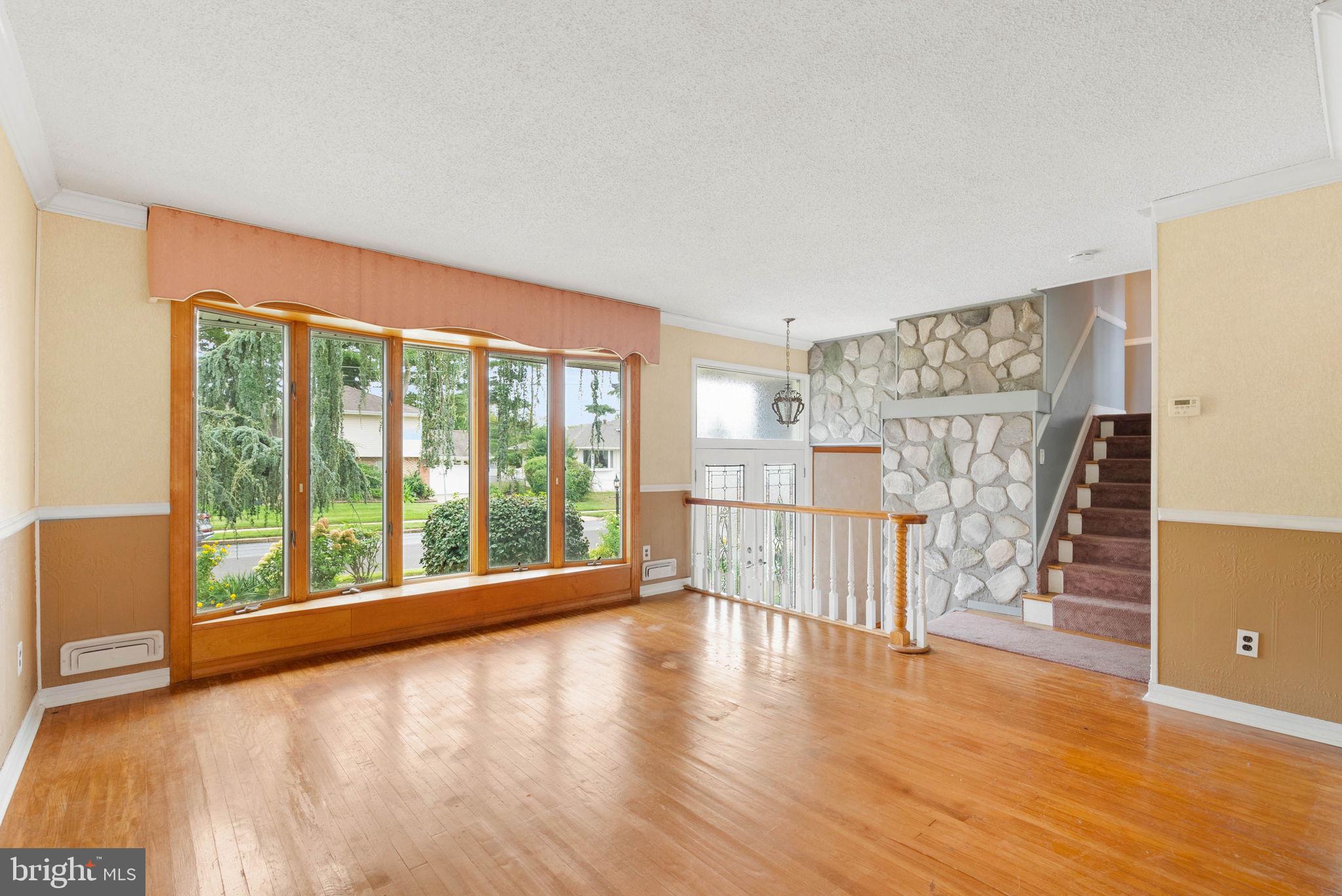 711 George Lane Glendora, NJ 08029 - Photo 10 of 43 a view of an empty room with wooden floor and a window