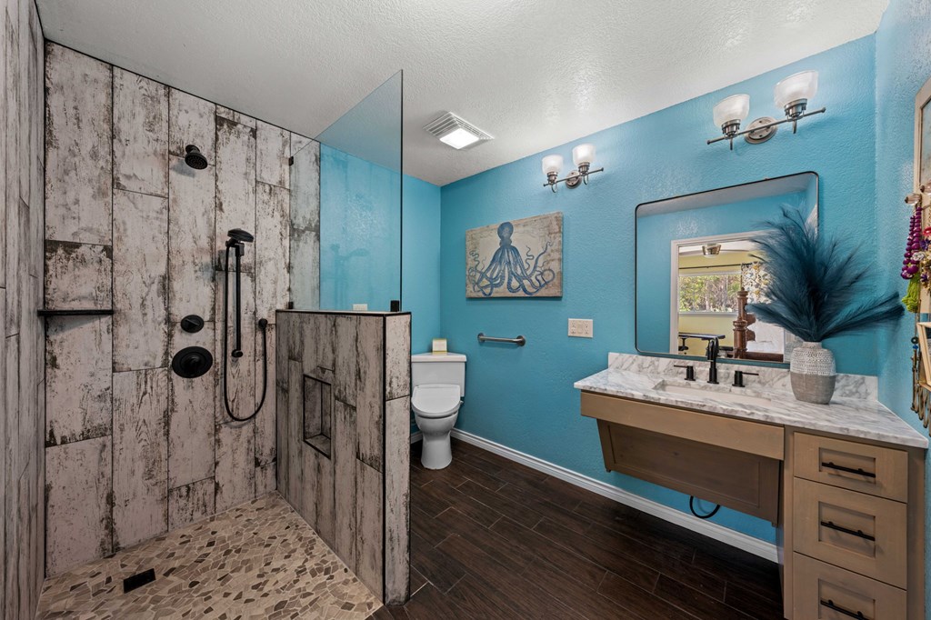 825 Golf Street Kerrville, TX 78028 - Photo 14 of 38 a bathroom with a double vanity sink mirror and shower