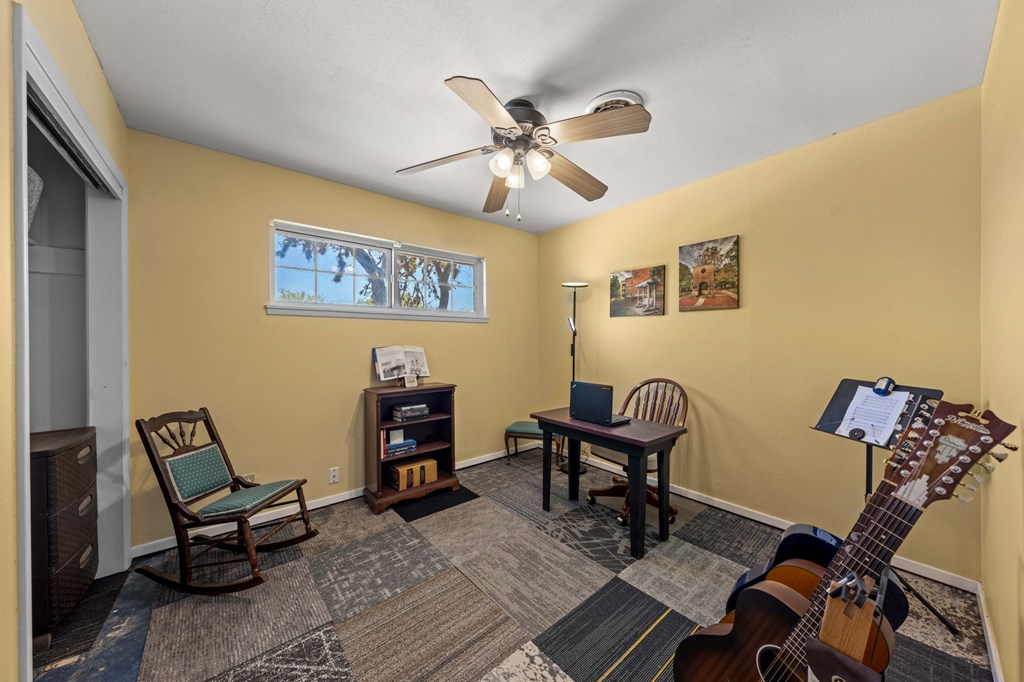 825 Golf Street Kerrville, TX 78028 - Photo 17 of 38 a view of a workspace with furniture and a ceiling fan