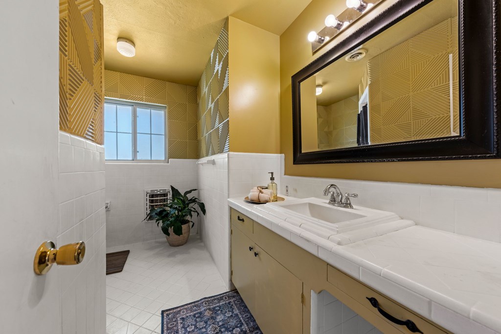 825 Golf Street Kerrville, TX 78028 - Photo 18 of 38 a bathroom with a double vanity sink and a mirror