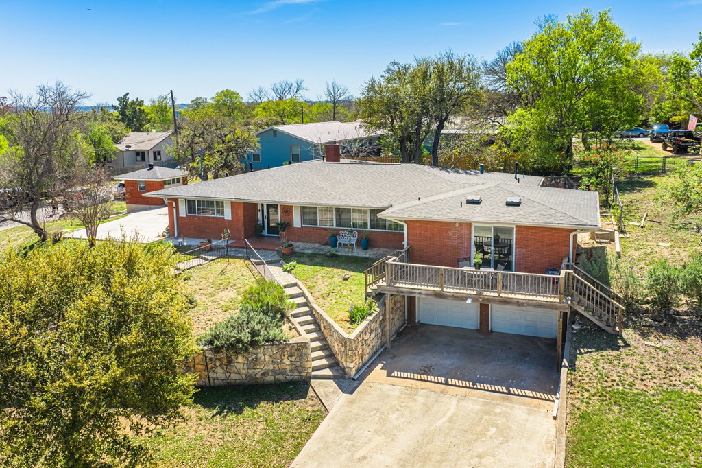 825 Golf Street Kerrville, TX 78028 - Photo 2 of 38 a aerial view of a house with swimming pool and large trees