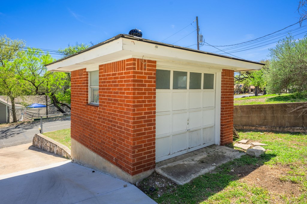 825 Golf Street Kerrville, TX 78028 - Photo 25 of 38 a front view of a house with a yard
