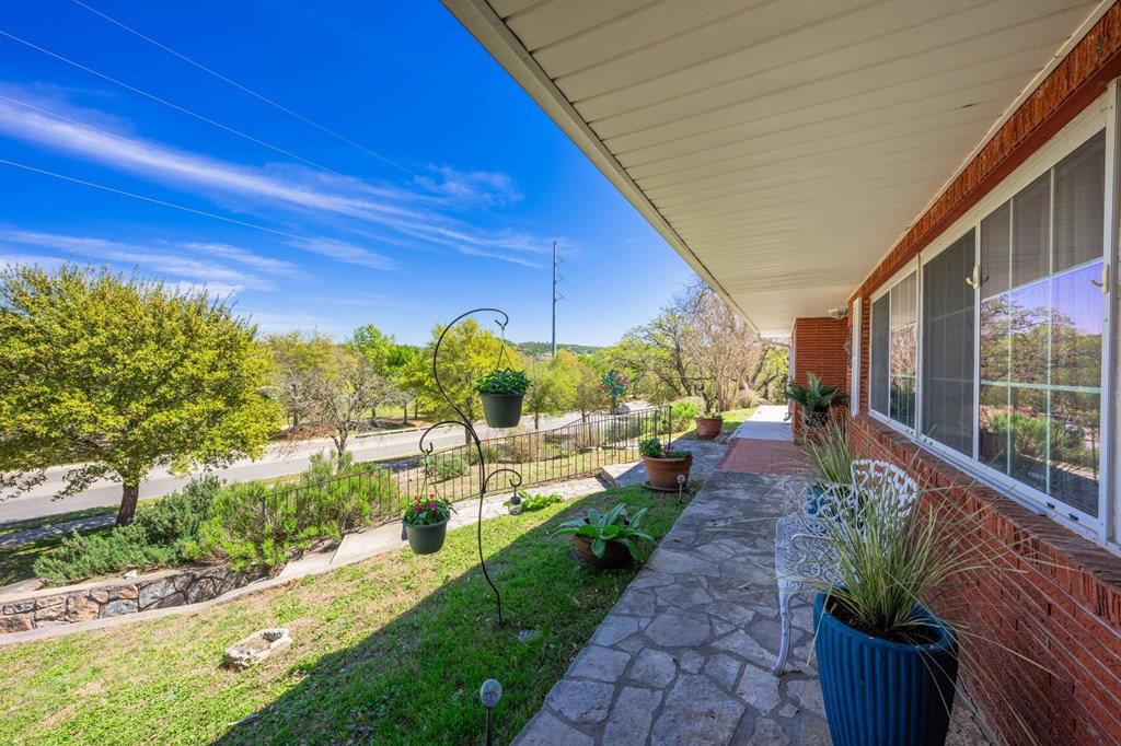 825 Golf Street Kerrville, TX 78028 - Photo 3 of 38 a view of a backyard with potted plants