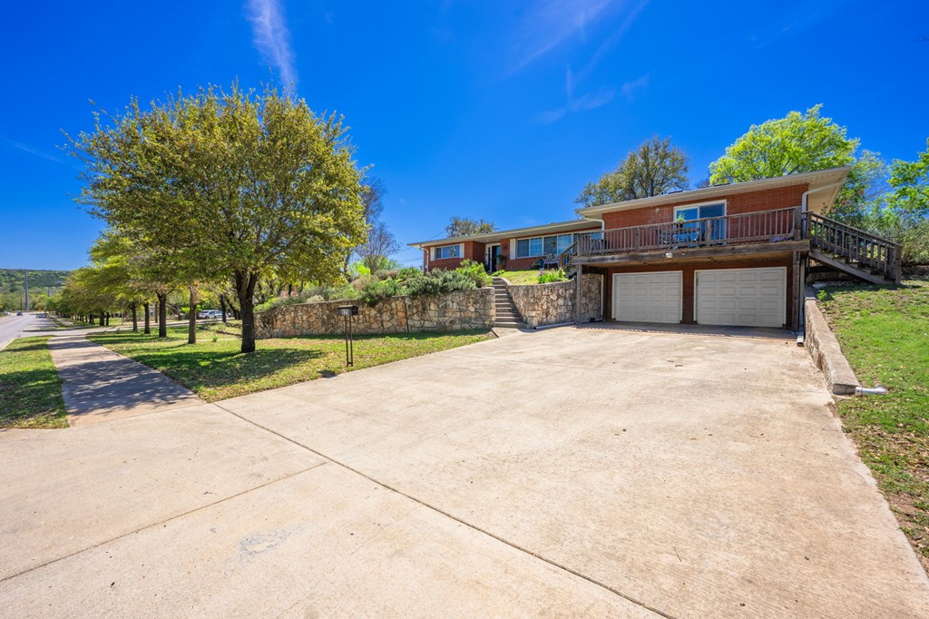 825 Golf Street Kerrville, TX 78028 - Photo 37 of 38 a view of a building with a yard