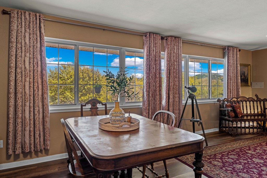 825 Golf Street Kerrville, TX 78028 - Photo 7 of 38 a view of a dining room with furniture window and wooden floor