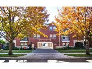 a sign board with buildings in the background